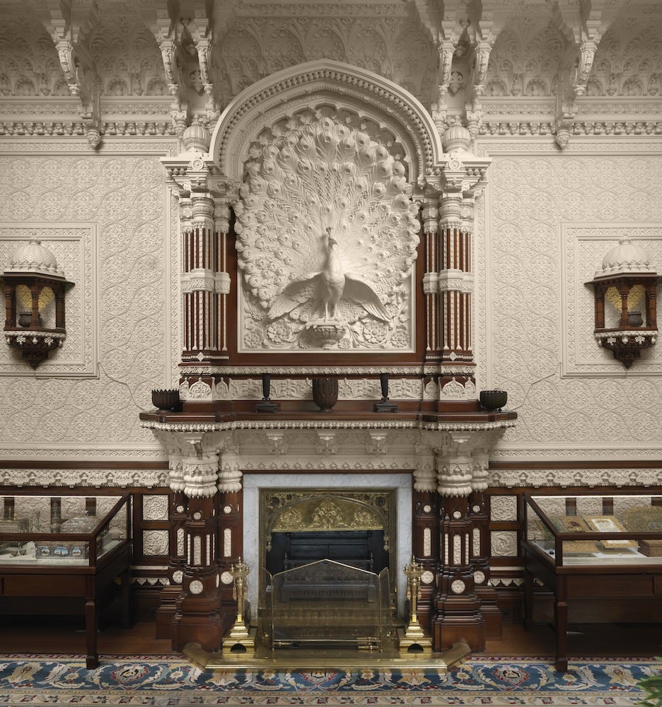 Molded peacock decoration over a fireplace