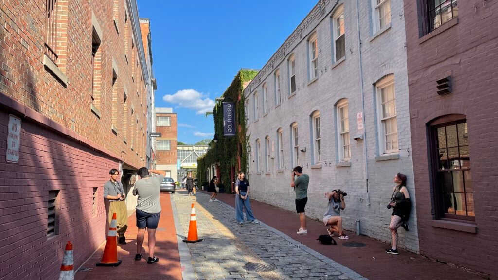 Students take photographs on location in Georgetown.