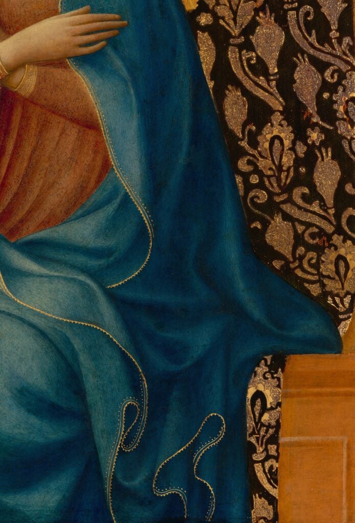 detail of the mantle of the Virgin Annunciate, with gold leaf on the hem of a blue skirt.