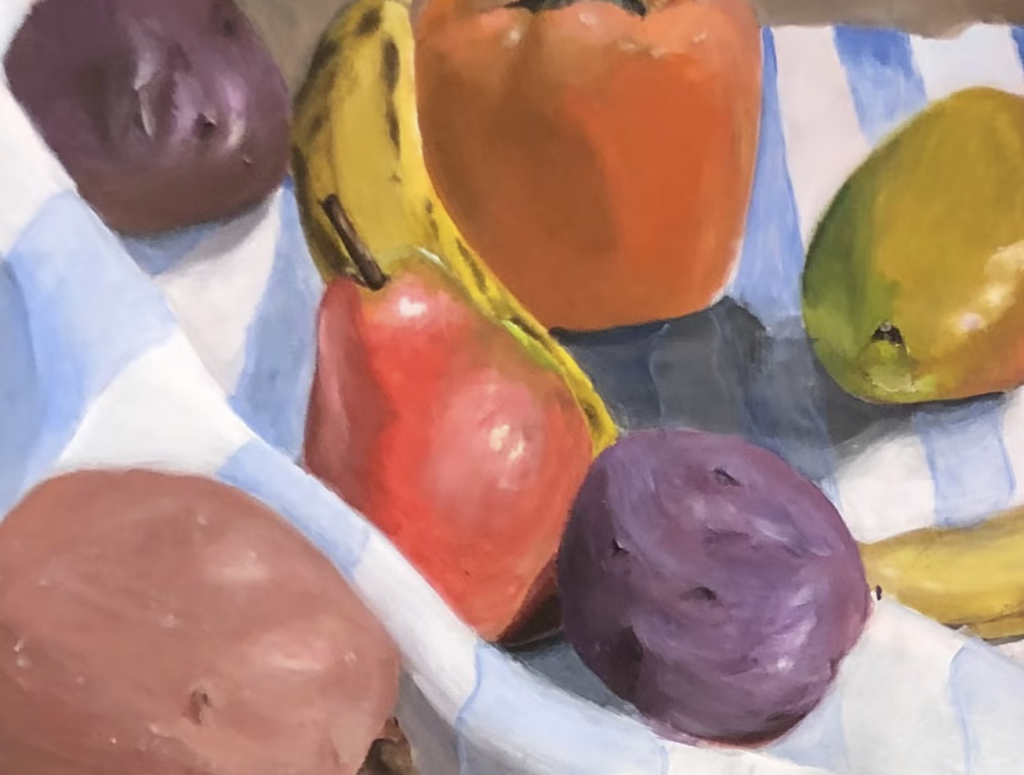 A still life of colorful fruit atop a blue and white striped tablecloth