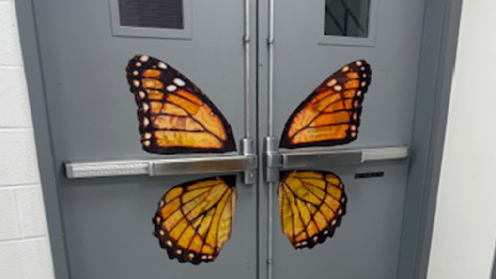 Butterfly door graphic "Trust the Process" with images of all art and design projects in the wings