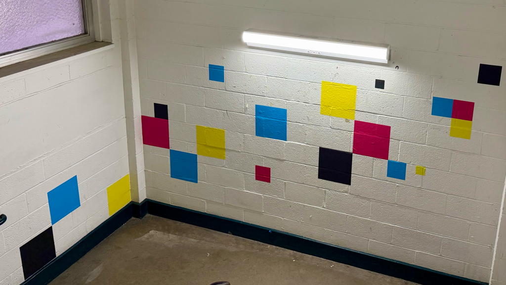 CMYK squares on the stairwell wall with a QR code